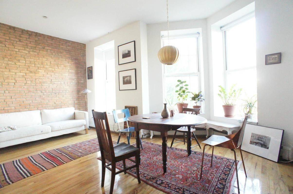 Beautiful renovated apartment with high ceiling brick facing walls in living room and bedrooms