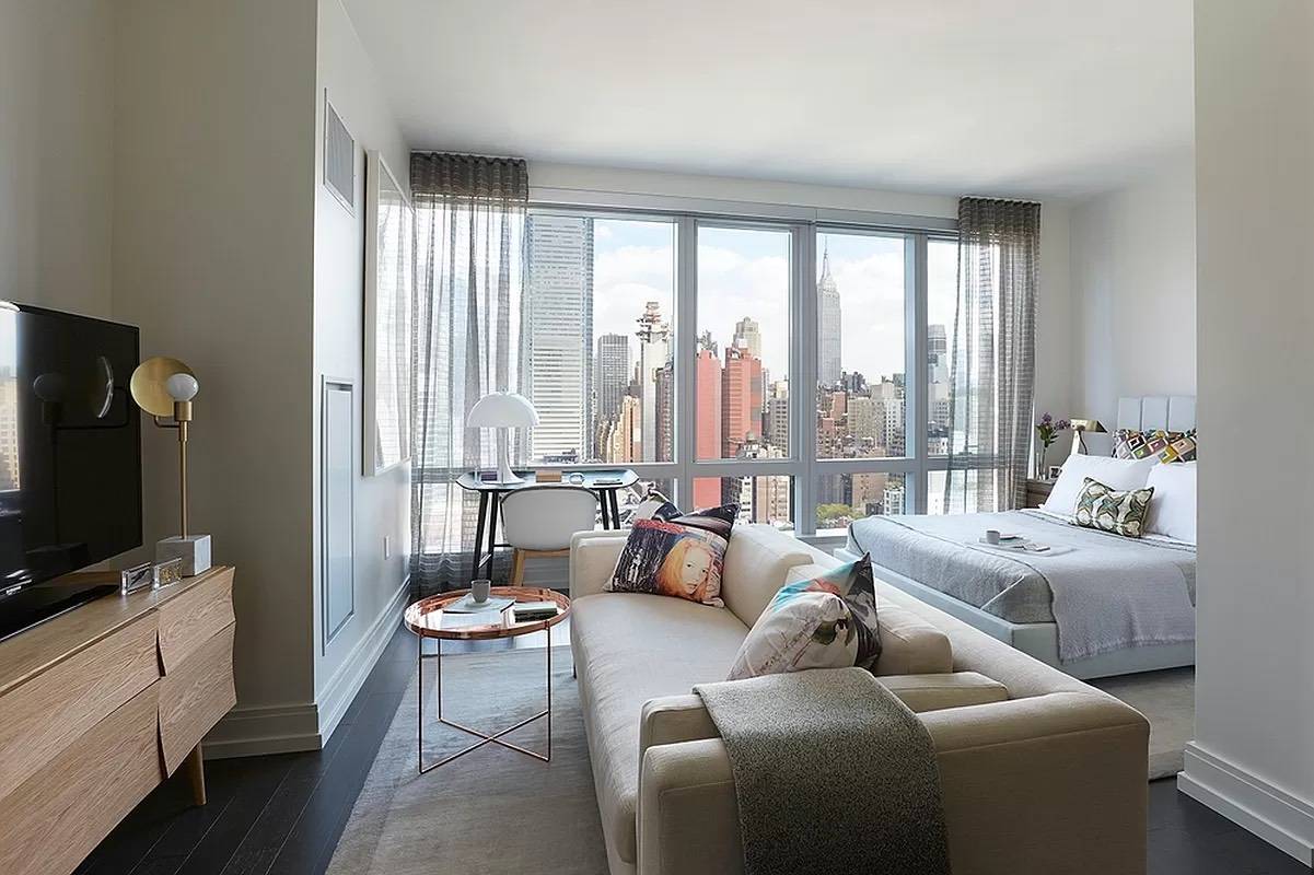FLOOR TO CEILING WINDOWS WITH A VIEW OF MANHATTAN