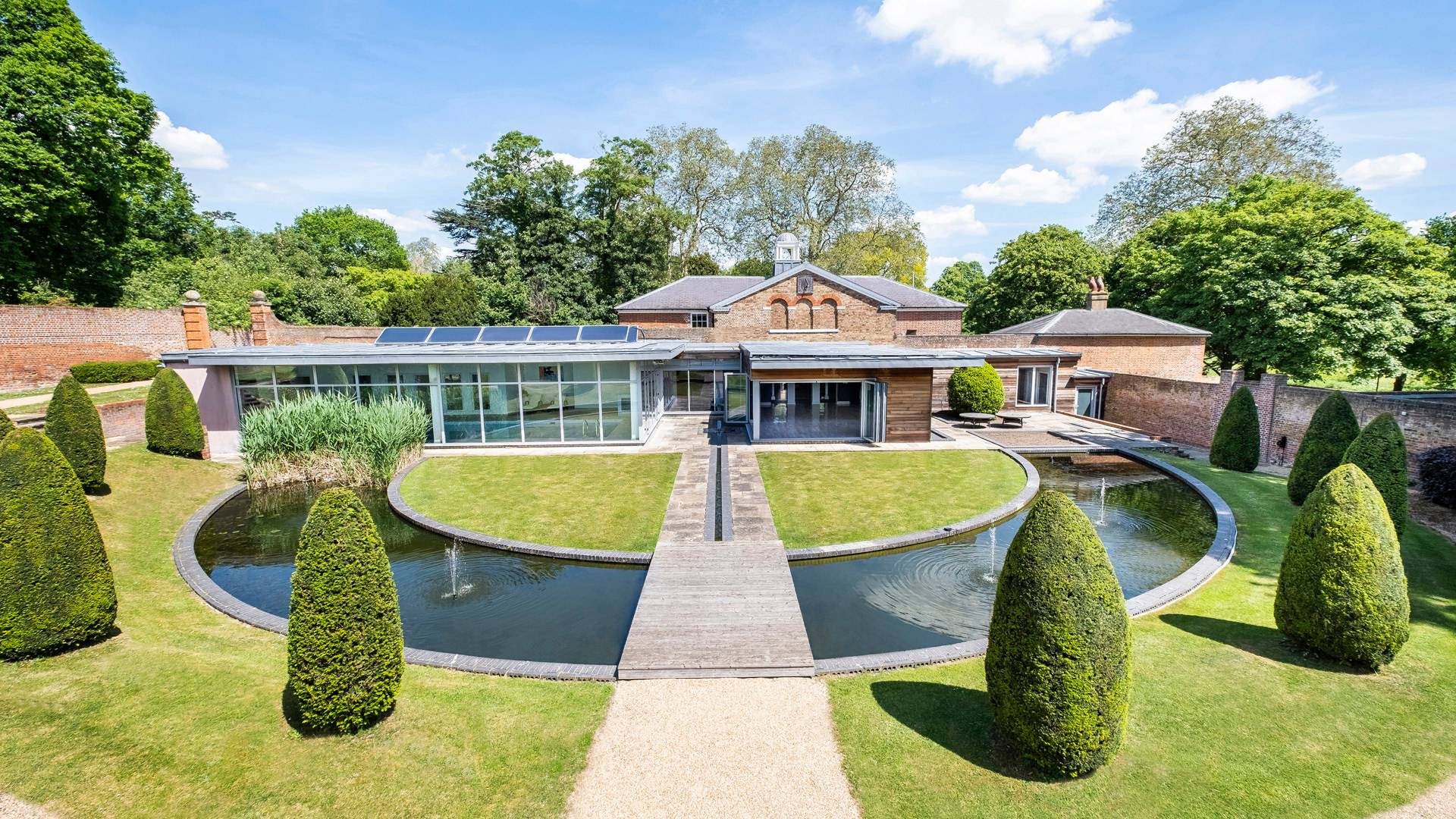 UNIQUE MODERN DISTINCTIVE GRADE II LISTED ECO MANSION WITH EXCEPTIONAL AND VERSATILE ACCOMMODATION AND A SEPARATE COTTAGE ALL SET WITHIN IMPRESSIVE WALLED LANDSCAPED GARDENS