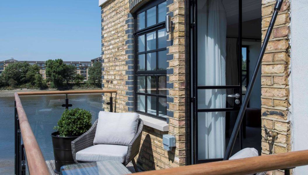 Beautiful three bedroom penthouse with balcony and river views in a newly converted, warehouse style gated development.