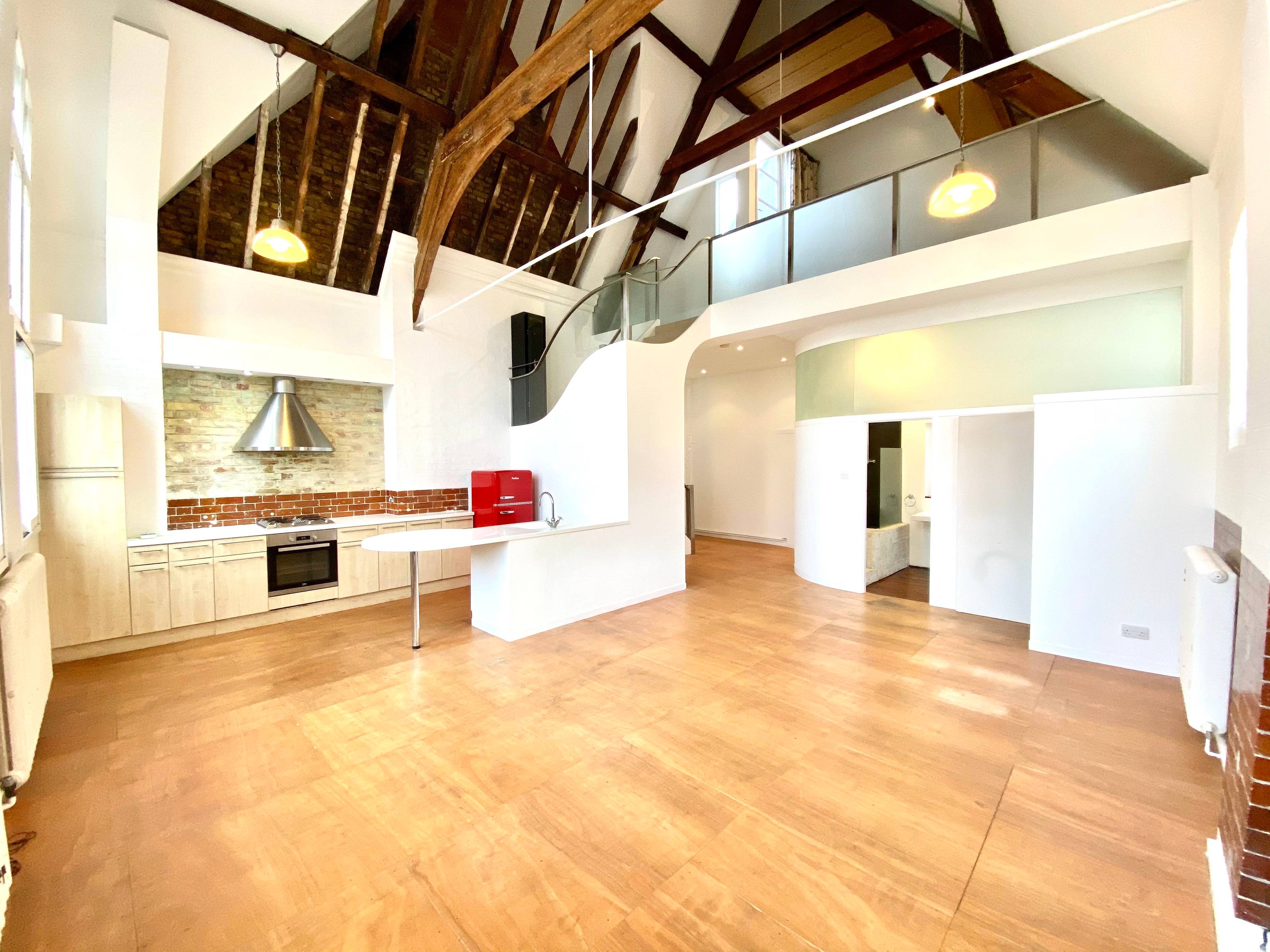 Boasting double height ceilings, this amazing property retains most of its original school house features, including parquet flooring, gigantic windows, and a decked roof terrace.