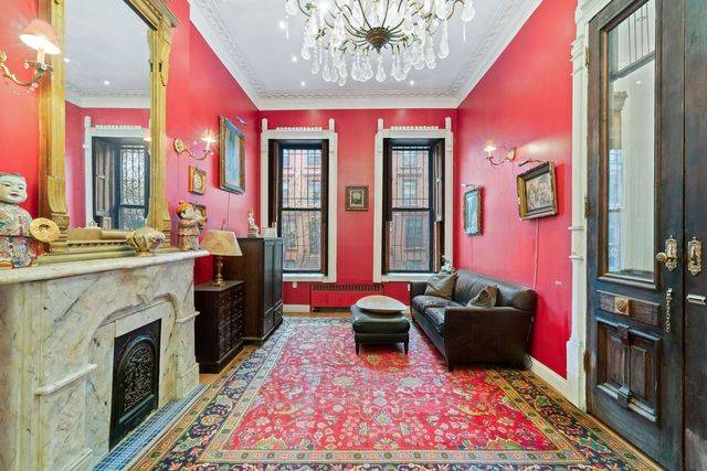 Nestled at 9 East 126th Street, this corner townhouse presents a remarkable opportunity,