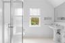 Bathroom featuring wainscoting, toilet, a healthy amount of sunlight, and tile patterned floors