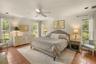 Spacious primary suite filled with natural light and peaceful views of the property