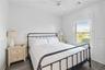 Bedroom featuring ceiling fan and dark hardwood / wood-style floors