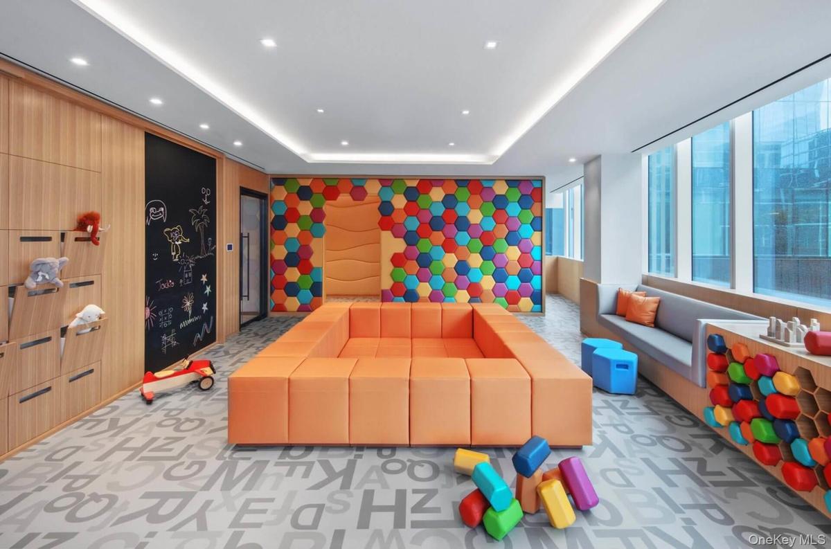 Rec room with recessed lighting, light colored carpet, and a raised ceiling