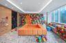 Rec room with recessed lighting, light colored carpet, and a raised ceiling