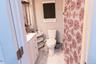 Bathroom featuring vanity, a shower with curtain, and light marble finish flooring