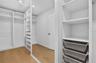 Master Walk In Closet with Built in shelves and drawers.