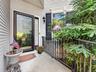 Raised landing with stylish storm door and handrail.
