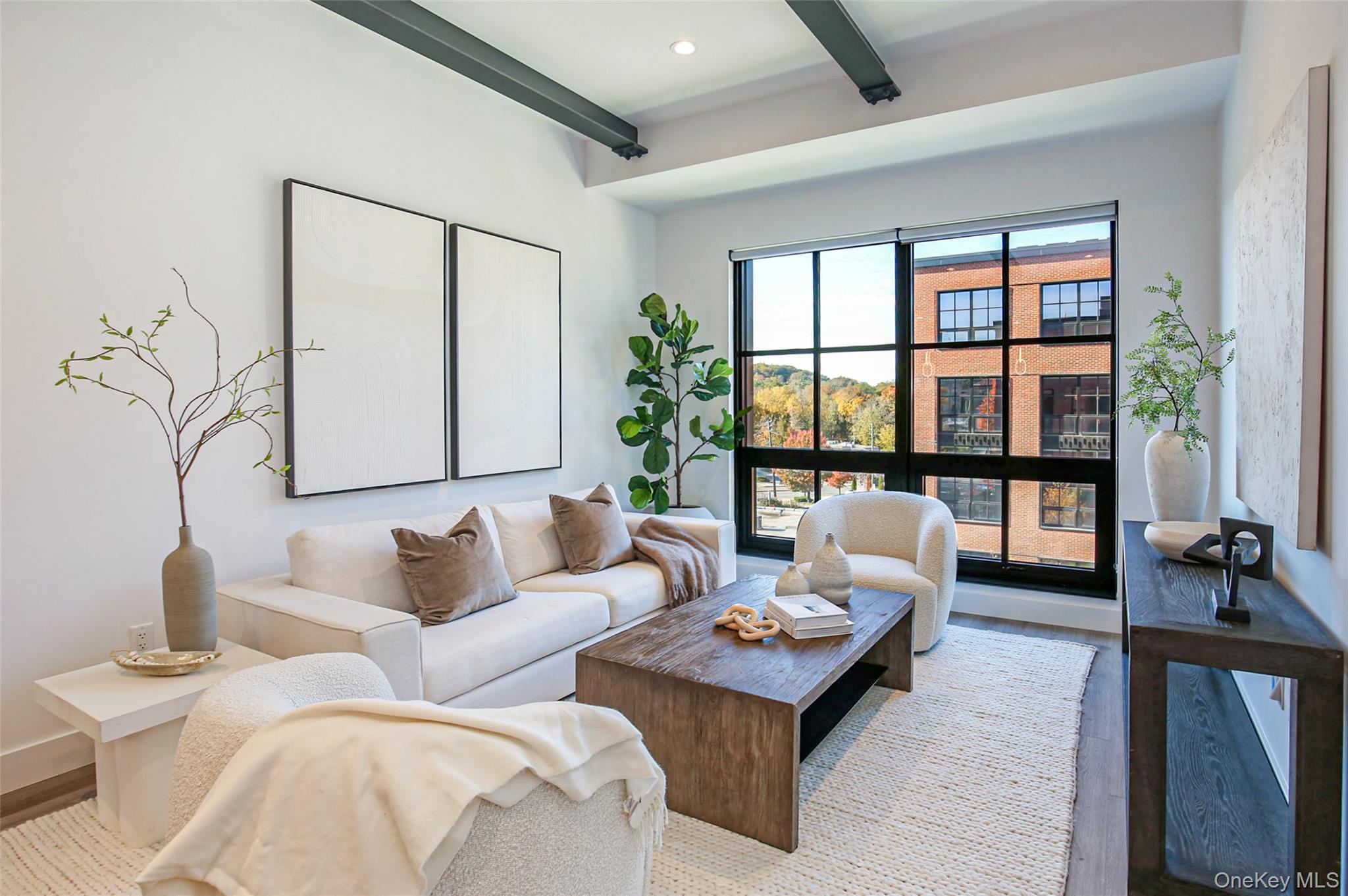 Living area with beam ceiling, wood finished floors, and recessed lighting