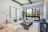 Living area with beam ceiling, wood finished floors, and recessed lighting