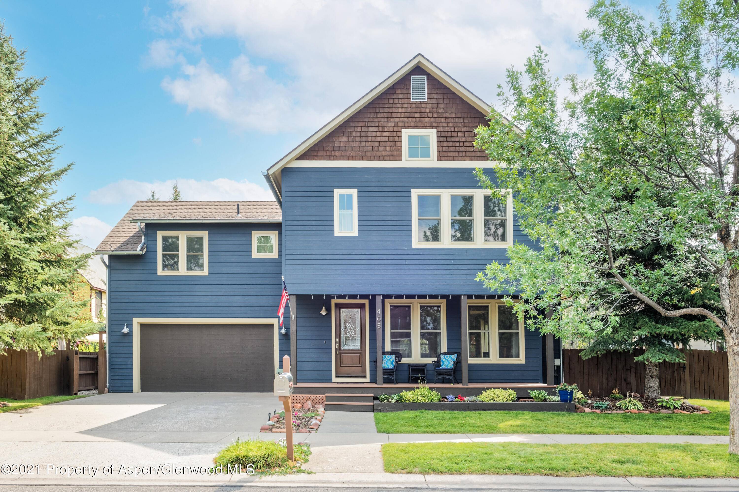Charming home with an open lower level floor plan including kitchen, dining and living room that walks out to an expansive patio and a large private landscaped yard.