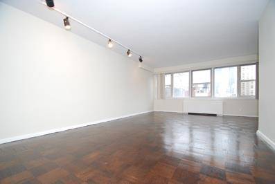 DO NOT MISS this beautifully renovated studio with an entire wall of windows facing North to the Empire State Building, parquet floors, track lighting, all amplified by a wall of ...