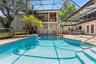Pool and entrance to separate apartment overlooking pool area