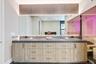 Cabinets with internal outlets and hidden ventilation slats on both ends of the cabinetry