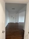 Hall with baseboards and dark wood-style floors