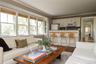 Living room with crown molding and dark wood-style flooring
