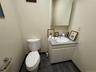 Half bathroom with vanity and dark tile patterned flooring