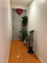 Hallway with hardwood / wood-style flooring