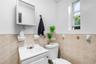 Bathroom featuring a single vanity, tiled walls, and an overhead medicine cabinet