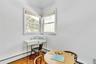 Home office featuring hardwood / wood-style floors and baseboard heating