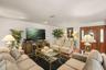 Inviting living room featuring a cozy wood-burning fireplace and abundant natural light
