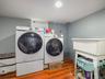 Laundry area featuring wood finished floors and separate washer and dryer