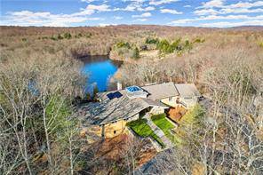This spectacular stone brick Contemporary that overlooks Deep Valley Lake will take your breath away !
