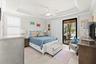 Primary Bedroom Featuring a Coffered Ceiling and Crown Molding