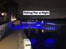 This pictures shows the fishing pier at Barefoot Beach at night.