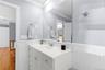 Bathroom with crown molding, a wainscoted wall, vanity, and light wood finished floors