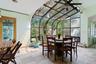 Sunroom featuring a baseboard heating unit and vaulted ceiling