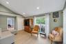 Vaulted ceilings with recessed lighting over wood-finish flooring