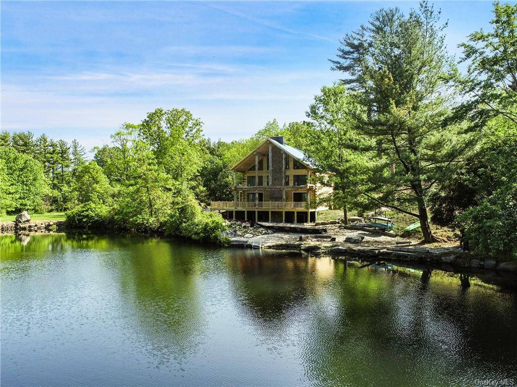 Modern waterfront Log Cabin sanctuary steps away from your own sandy beach on Quarry Lake, a pristine, deep, spring fed lake.