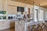 Chef’s kitchen with oversized lilac marble island and custom cabinetry