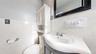 Bathroom with tile walls, vanity, and wainscoting