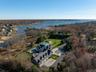 Aerial view of property and surrounding area featuring a large body of water