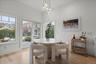 Dining room with light wood-type flooring and a chandelier