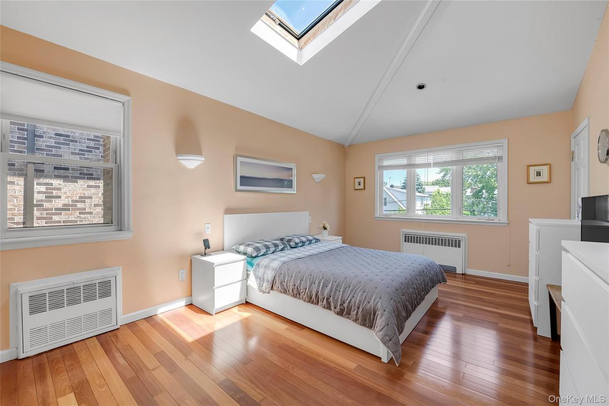 Primary bedroom #2 on the 2nd floor with a skylite with 2 windows & 3 spacious closets