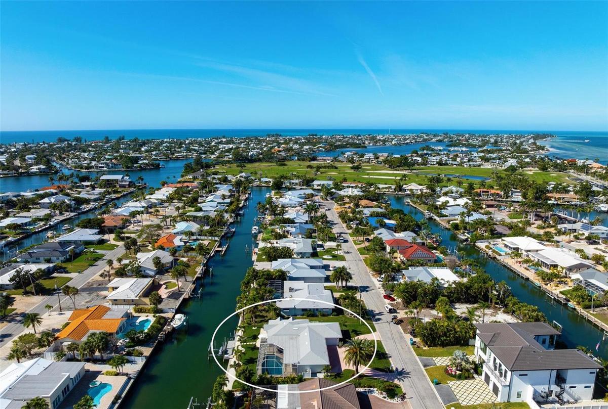 100 feet of waterfront with southern exposure! With aerial views to the Key Royale Club.