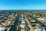 100 feet of waterfront with southern exposure! With aerial views to the Key Royale Club.