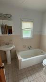 Full bathroom featuring a garden tub and tile patterned flooring