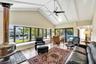 Living Room with large bay windows overlooking the water with wood burning fireplace
