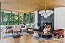 Great room with 10’ height and soaring glass walls and woodburning fireplace with water views