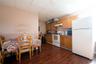 Kitchen with white appliances, a drop ceiling, and dark hardwood / wood-style floors