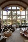 Living area featuring a chandelier, high vaulted ceiling, beamed ceiling, and expansive windows