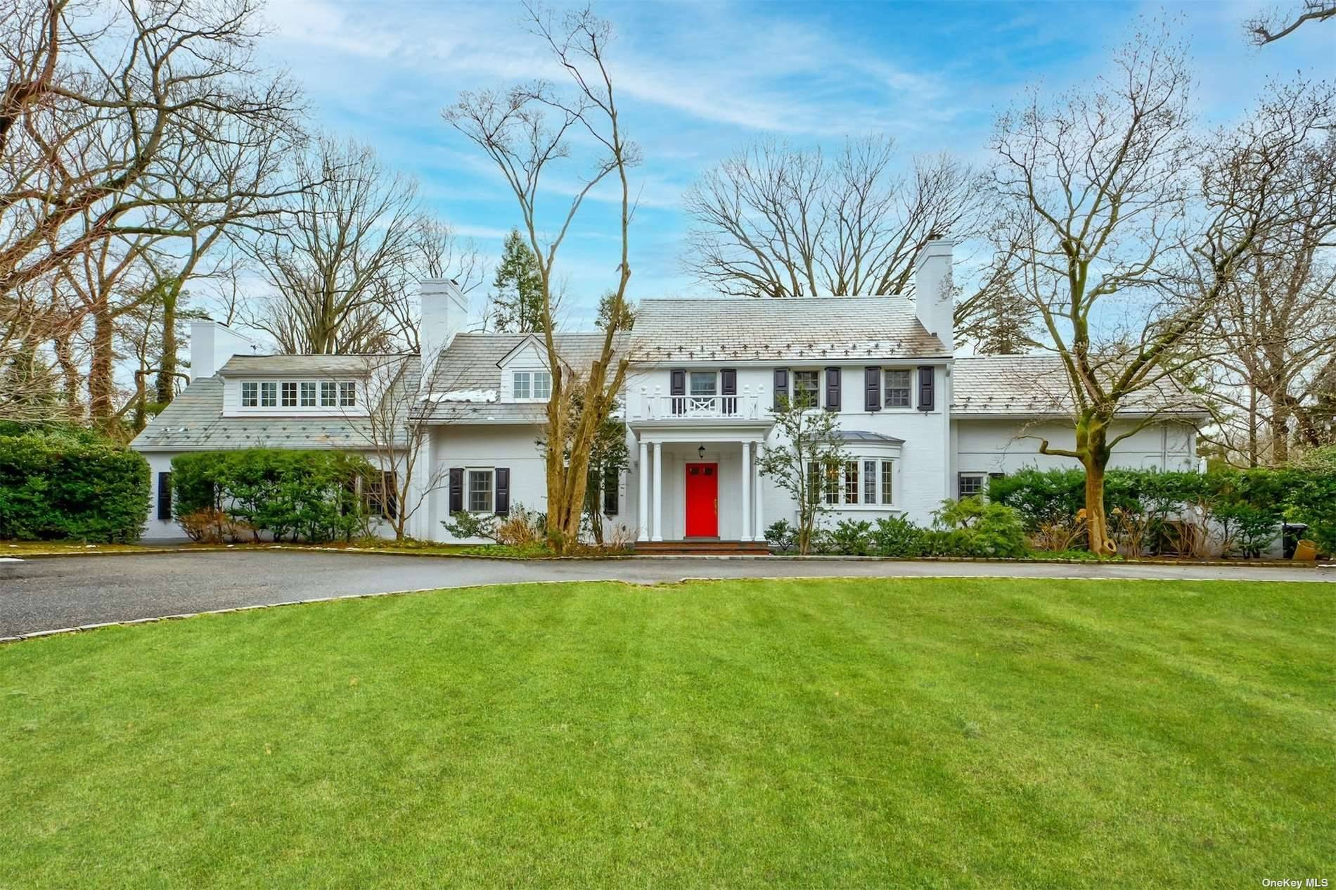 Located on beautiful and private Knolls Lane in Flower Hill, this 1937 Colonial, set on a shy 1.