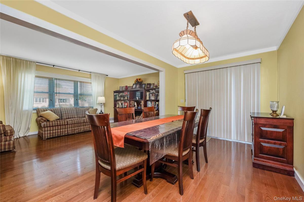 Hardwood flooring throughout, crown molding, cased openings, and a built-in bookshelf