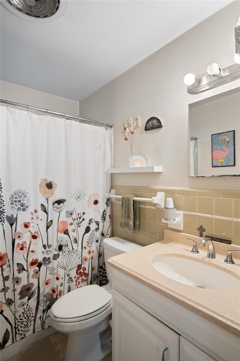 The bathroom has a shower and tub.